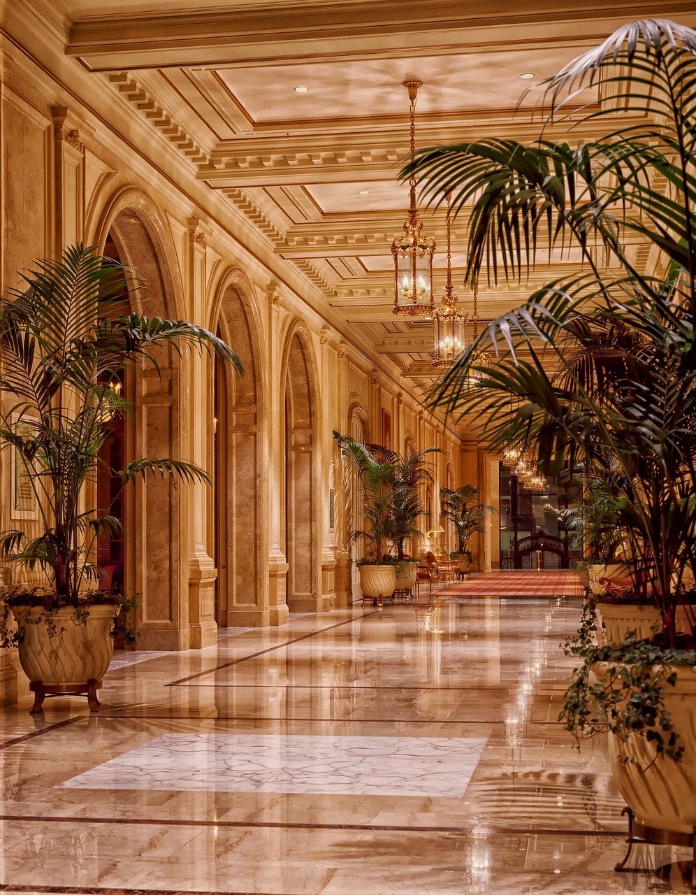Warm stone corridor with lantern light and arched colonnades inside Marellune