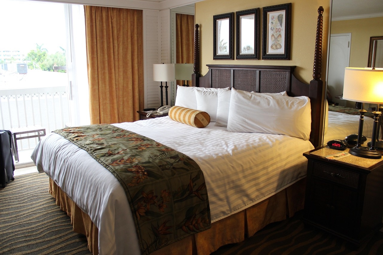 Daylit classic room with four-poster bed, botanical prints and garden doors