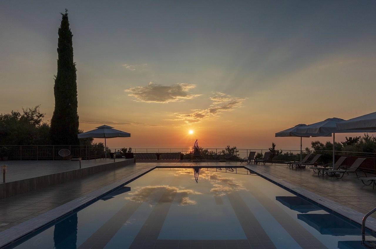 Sunset terrace with a still pool reflecting the evening sky